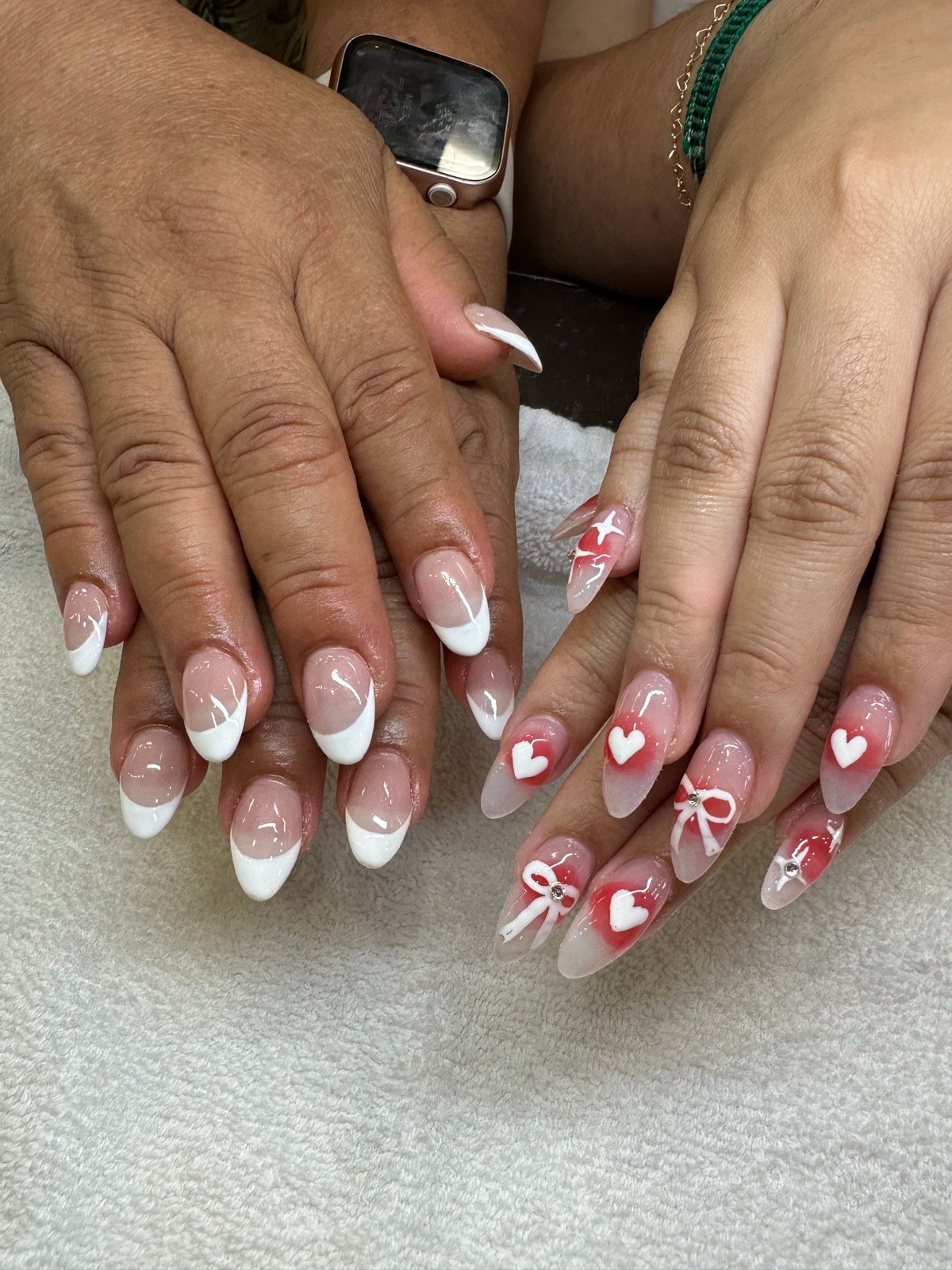 Romantic almond nails with hand-painted hearts and bow accents
